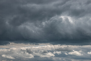 Dramatic rainy and stormy sky with heavy clouds as a background. - obrazy, fototapety, plakaty