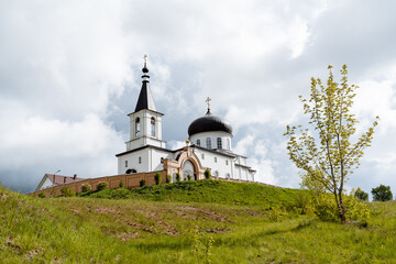 The Church of the Archangel Michael the city of Birsk Russia Bashkortostan, an Orthodox temple, a monastery stands on a mountain, a brick fortress wall, a white church.