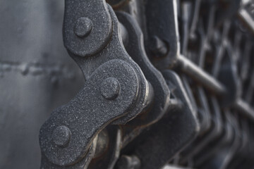 View of the metal chain of the mechanical unit of an old steam locomotive closeup, piece of...