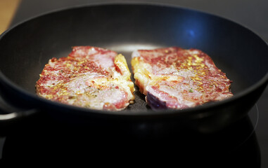 Juicy beef tenderloin is cooked in a skillet.