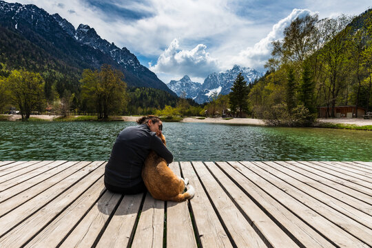 
a woman and her best friend enjoy the amazing mountain views over a small lake

Girl with dog