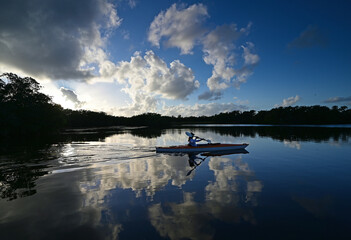 Woman kayaking on Paurotis Pond in Everglades National Park, Florida on calm sunny afternoon..