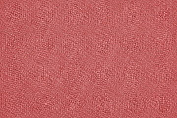 Light red woven surface close-up. Linen texture. Fabric background. Textured braided simple backdrop
