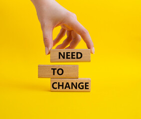 Need to change symbol. Concept words 'Need to change' on wooden blocks. Beautiful yellow...