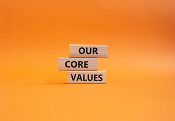 Our core values symbol. Concept words 'Our core values' on wooden blocks. Beautiful orange...
