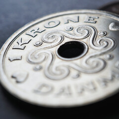 1 Danish krone coin close up. National currency of Denmark. Square money illustration for news about economy or finance. Banking and credit. Wages and taxes. Macro