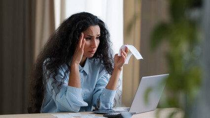 Worried upset young businesswoman accountant bookkeeper bank worker feel stressed about high tax check costs outcomes utility bills unpaid bank debt sit at home anxious of money crisis nervous analyst