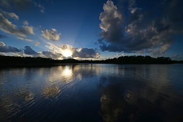 Colorful sunset cloudscape reflected on calm water of Paurotis Pond in Everglades National Park, Florida.