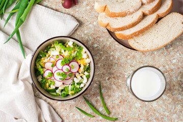 Chopped ingredients for okroshka in a bowl on the table. Top view