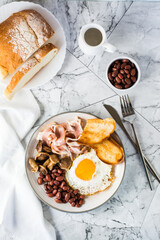 Traditional English breakfast with egg, bacon, beans, mushrooms and toast. Top and vertical view
