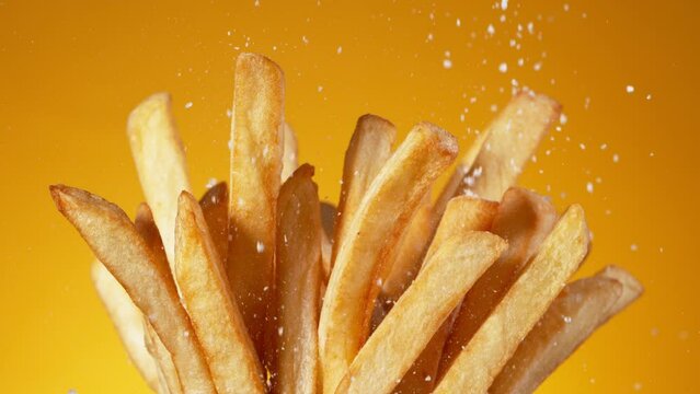 Super Slow Motion Detail Shot of adding Salt on Fresh French Fries at 1000fps.