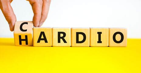 Cardio or hardio symbol. Businessman turns wooden cubes and changes concept words hardio to cardio. Beautiful white background. Sport, healthy lifestyle and cardio or hardio concept. Copy space.