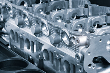 open block of four cylinder petrol engine. Close-up, industrial metalworking concept