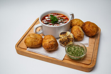 borscht with donuts on a white background