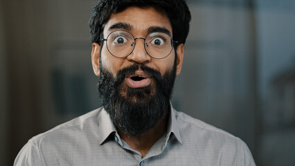 Male portrait surprise emotion enthusiastic surprised shocked arabian amazed man in eyeglasses make big eyes indian businessman winner demonstrate wow emotion face expression say wow happiness triumph