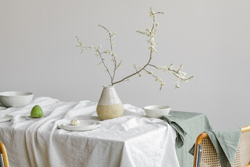 Elegant table setting with cherry brunch in craft vase , cherimoya fruits, garlic in craft ceramic...