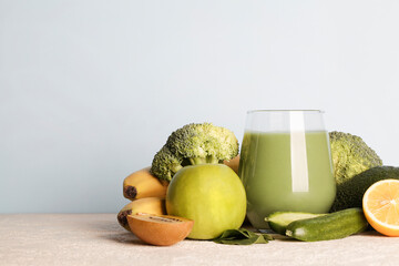 fresh green smoothie in glass with vegetables on blue background. vegan food, healthy lifestyle.Healthy detox diet copy space