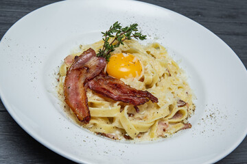 carbonara pasta on a gray wooden background