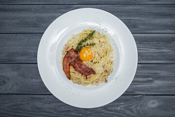 carbonara pasta on a gray wooden background