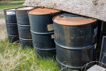 Old Metal Oil Barrels Rusting beside Shed in Wyoming