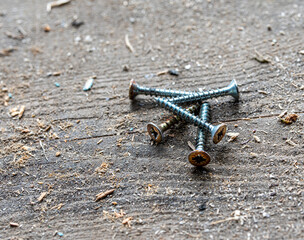 metal screws on an old wooden table