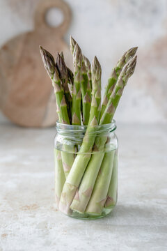 Green asparagus in a glass jar filled with water