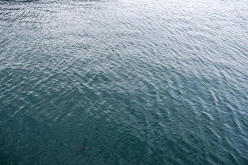 Sea water surface calm with small ripple. Ocean deep blue color background,.
