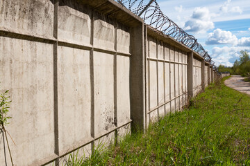 Barbed wire fence with the sky in the background.