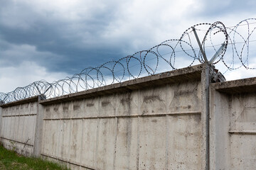 Barbed wire fence with the sky in the background.
