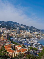 Fototapeta na wymiar Monaco City buildings and the harbour on a beautiful summer day