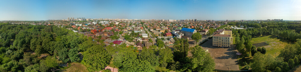 Fototapeta na wymiar aerial panorama of the urban landscape of the city of krasnodar near the park Arboretum of KSAU on a sunny day at the end of spring
