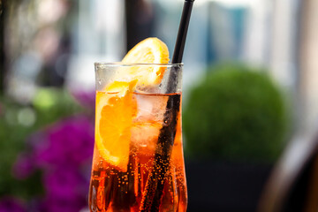 Aperol spritz with orange slice at outside cafe Aperol is an Italian aperitif made of herbs and soda