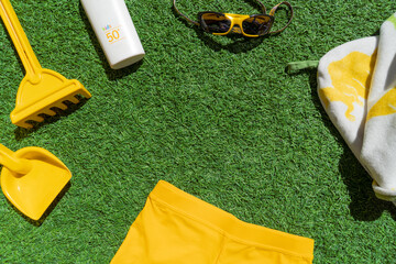 Naklejka premium children accessories an clothes for the summer. swimwear, skincare suntan lotion, sunglasses, shovel, rake