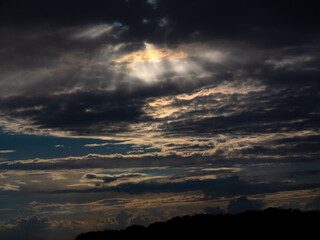 Late twilight before thunderstorm. Solar twilight, abstract sunset. Windy early evening clouds at sunset over the trees of the forest.
