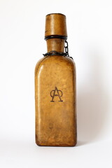 Glass bottle covered with leather with a stamp, vintage.