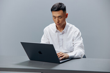 manager sits at a desk in front of a laptop Internet isolated background