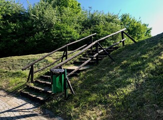 Wooden bridges and steps in the area of the Tatar mound among bushes and tall trees are a place for walks and recreation of locals in Przemyl, Poland. 