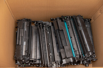Collecting laser cartridges from laser printers for recycling.
