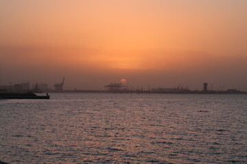 Fototapeta na wymiar sunset over sea port with ships