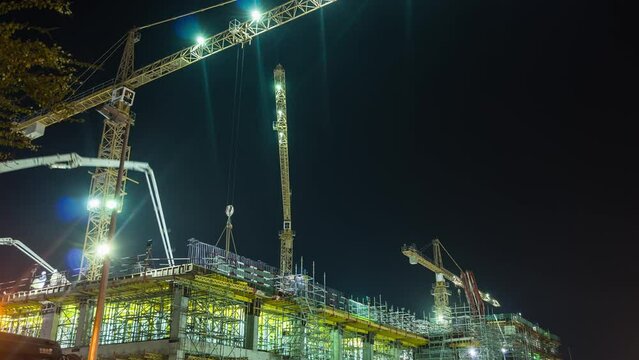 night illumination dubai city hotel construction working crane panorama 4k time lapse uae