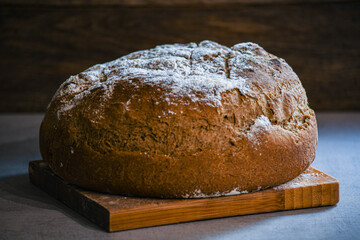 Homemade, special, Ukrainian bread on the kitchen table and a towel.
