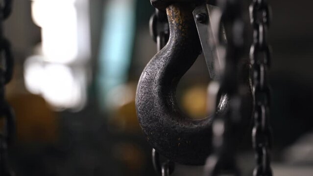 Industrial concept. Close-up of a slewing chain hook crane in a factory workshop