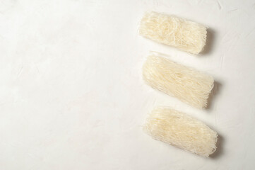 raw Korean starch tangen noodles on a gray background, top view, copy space.