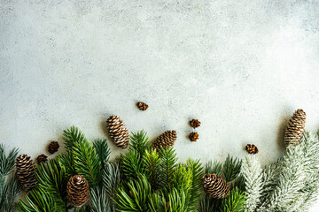Overhead view of festive pinecones and fir branches on a table for Christmas
