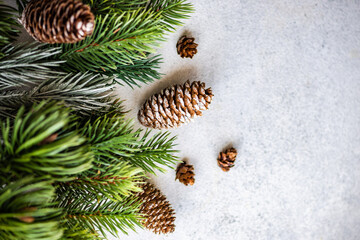 Overhead view of pinecones and fir branches on a table