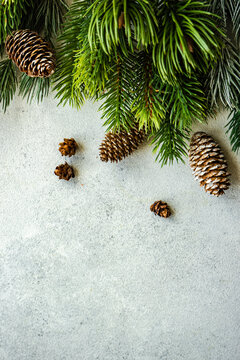 Overhead view of pinecones and fir branches on a table