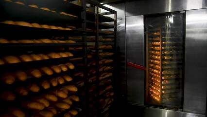 Loafs of bread in a bakery on an automated conveyor belt