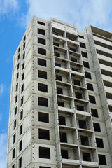 Obraz premium Construction of a residential building. Tower cranes building a new residential building. Unfinished panel house and construction crane