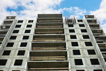 Construction of a residential building. Tower cranes building a new residential building. Unfinished panel house and construction crane