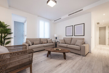 Modern living room with three-seater sofas and another two-seater, rattan chair and wooden side table with light wooden floor